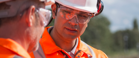 An image showing professionals from the energy industry in the field, wearing high viz PPE.