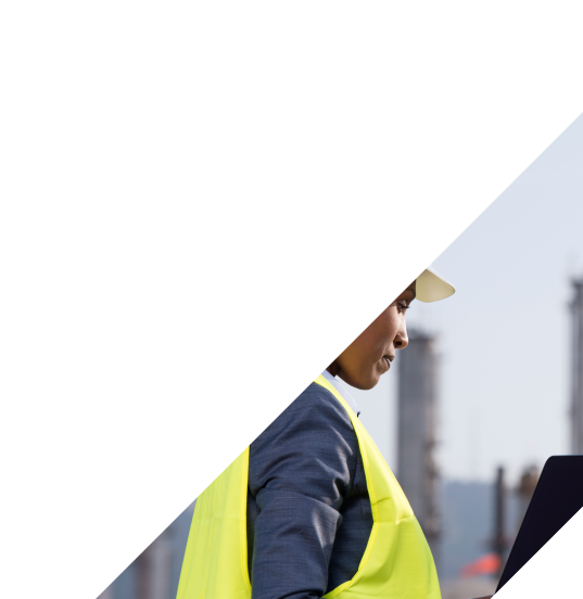 A woman in a high viz vest reads emission data on a tablet, the kinds of high-precision readings provided by Ecotec's specialized equipment.